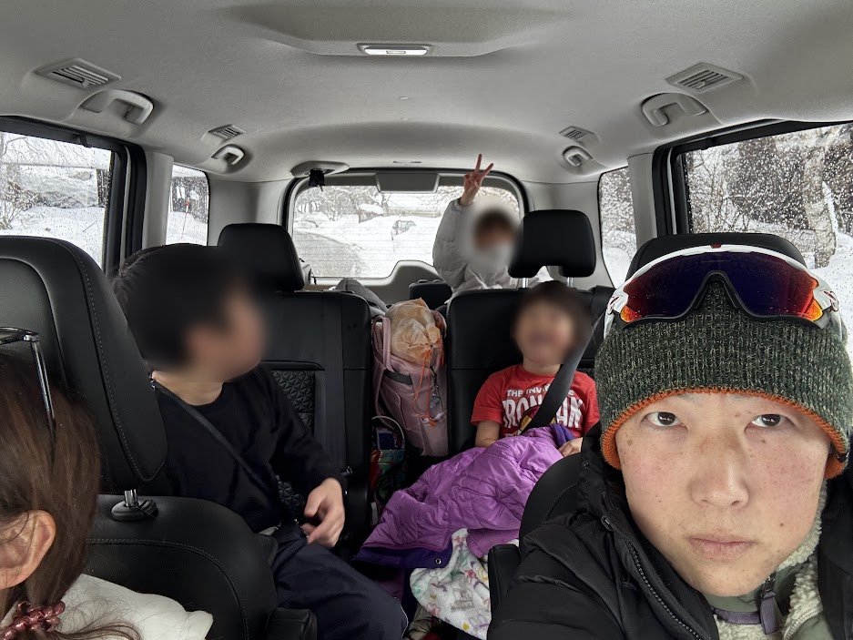 雪山からの帰り道、家族用のミニバンの車内で子どもたちと